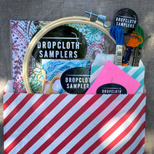 Load image into Gallery viewer, Turn your Dropcloth Sampler into a kit with all the supplies you need to get started: embroidery hoop, three colors of embroidery thread, embroidery needle, Creativebug coupon for a free trial, and a Dropcloth Samplers pin.