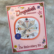 Dropcloth Embroidery Ice Cream kit packaging. Each kit includes sampler, instructions, hoop, needle, thread, and a free trial for a Creativebug class. 