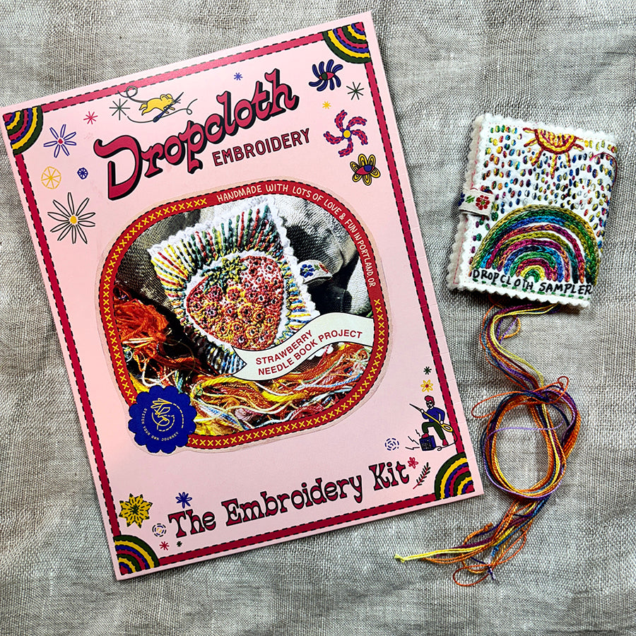 Dropcloth Embroidery Strawberry Needle Book kit. Each kit includes sampler for one needlebook, instructions, threads, wool for the inside lining, one snap, one ribbon, and a free trial for a Creativebug class. 