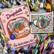 Load image into Gallery viewer, Dropcloth Embroidery Tea and Tomatoes Needle Book kit. Each kit includes sampler for one needlebook, instructions, threads, wool for the inside lining, one snap, one ribbon, and a free trial for a Creativebug class. 
