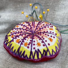 Rebecca Ringquist virtual class will guide and instruct how to stitch and sew Dropcloth Samplers Starburst into functional and fun pin cushion for yourself or your favorite embroiderer.
