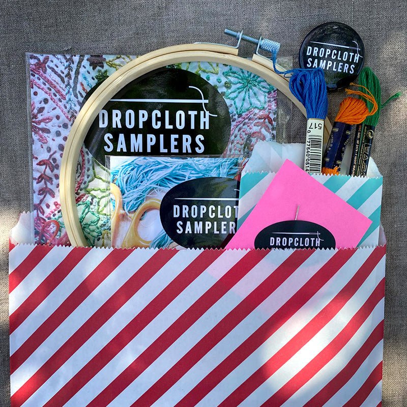 Turn your Dropcloth Sampler into a kit with all the supplies you need to get started: embroidery hoop, three colors of embroidery thread, embroidery needle, Creativebug coupon for a free trial, and a Dropcloth Samplers pin.