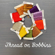 Image of Dropcloth curated ten paper bobbins full of embroidery floss. Arrives ready to use, already organized.